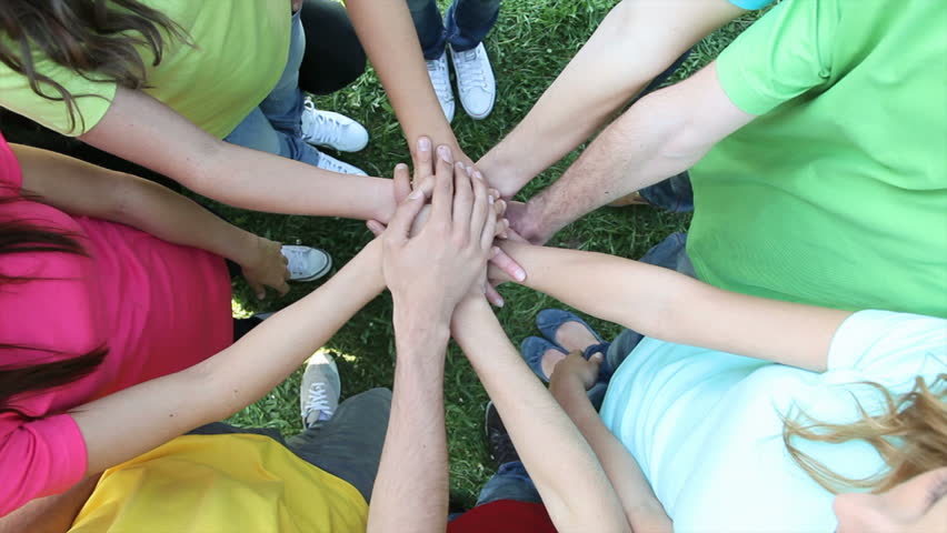 Group Of People Coming Together And Joining Hands To Form A Happy Close