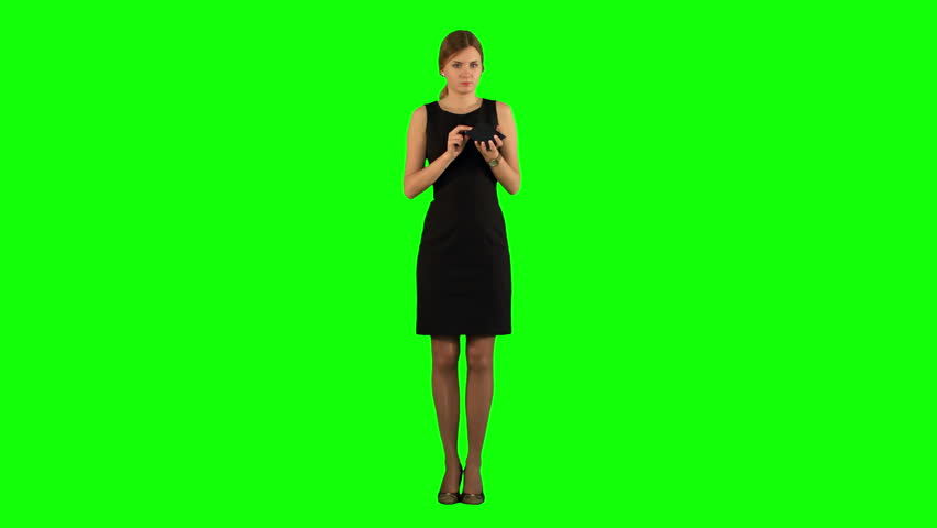 MEDIUM CLOSE UP OF A YOUNG WOMAN APPLYING BLUSHER ON GREEN SCREEN Stock