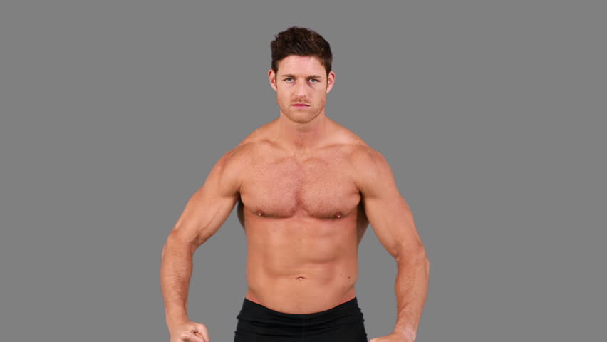 Shirtless Man Flexing Muscles In Slow Motion On White 