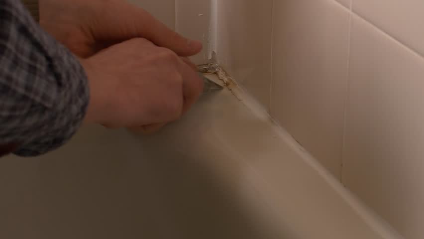 Moldy Ed Caulking On Bathroom Tub Stock Footage Video Man Cuts Into Moldy Ed Caulking From Bathroom Tub 4k Stock Footage Clip