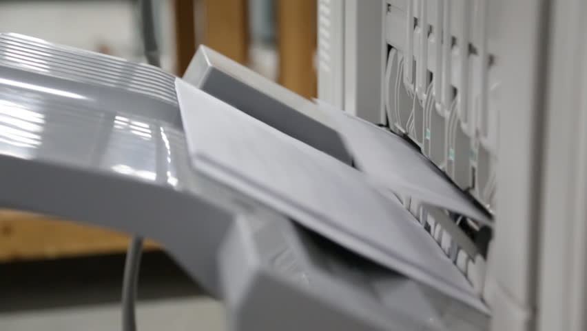 mcu-paper-coming-out-of-printer-into-tray-stock-footage-video-13789076