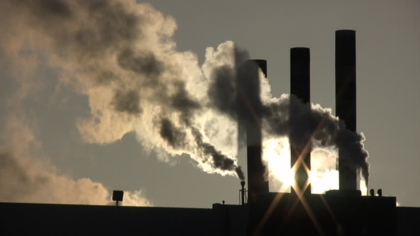 fumes-billow-out-of-a-giant-smoke-stack-against-the-sunny-sky-high