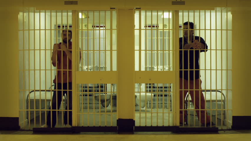 Inmate Looking Around From The Bars Of His Prison Cell. Desaturated Color. Stock Footage Video