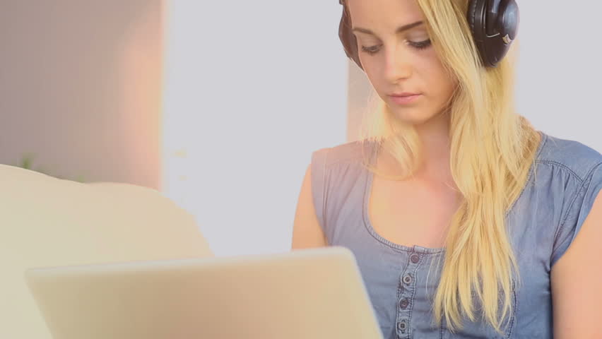 Smiling Blonde Woman Listening Music And Danci