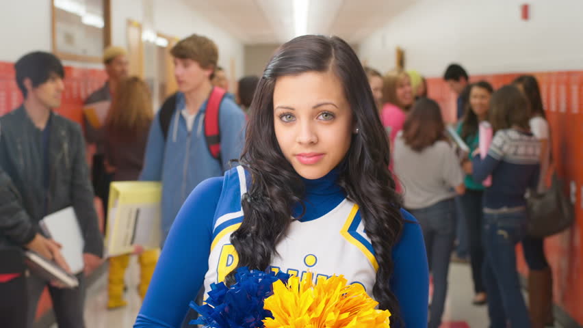 A Cute Cheerleader Looks Into The Camera With A Str