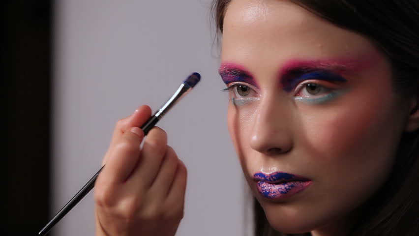 Makeup Modelled After A Cell Phone professional makeup artist putting cosmetics on model Makeup Modelled After A Cell Phone professional makeup artist putting cosmetics on model