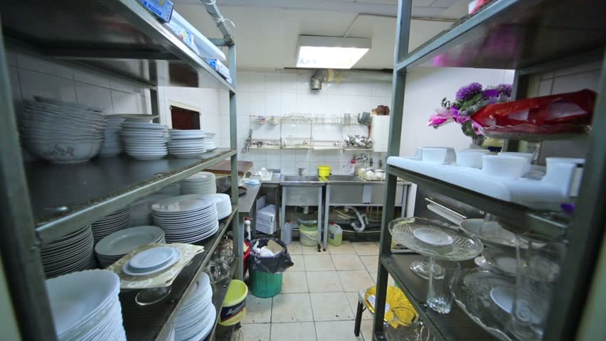 Kitchen At The Restaurant With Dishes Rack And Sink For Washing Stock ...