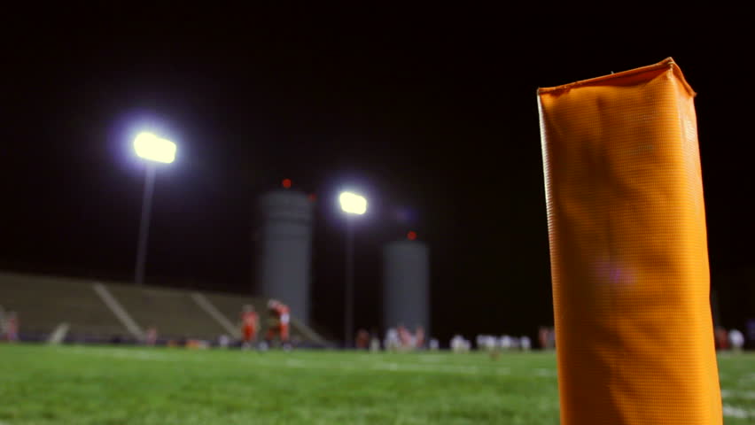 Rack Focus To An End Zone Pylon On A Football Field. Stock Footage