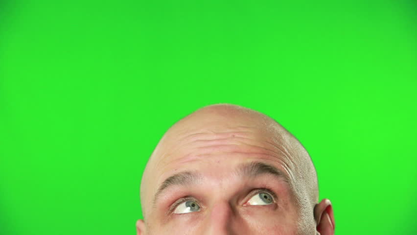Close Up Of Man Head And Eyes Squinting Against A Green Screen Stock