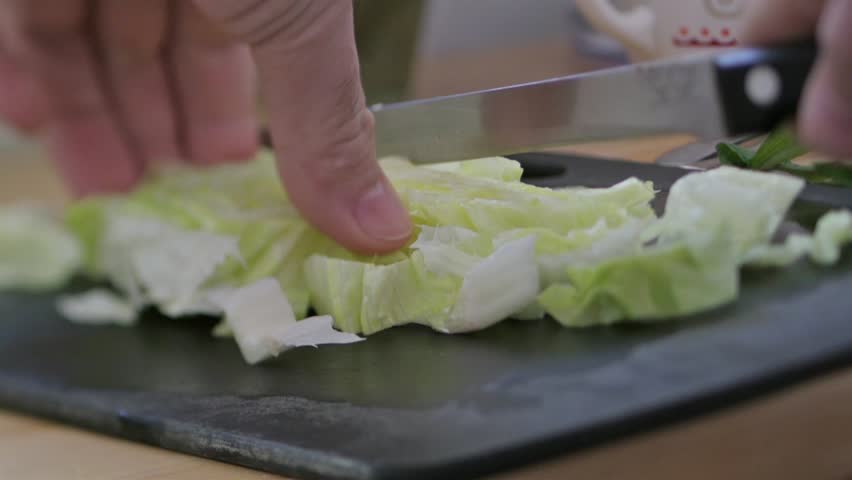 Kitchen Table Close Up close-up of chef hands slicing fresh mushrooms on wooden kitchen Kitchen Table Close Up close-up of chef hands slicing fresh mushrooms on wooden kitchen