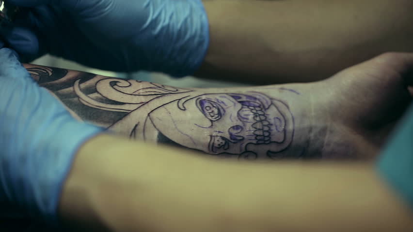 tattoo artist working man draws on his arm woman s face tattoo artist working man draws on his arm woman s face