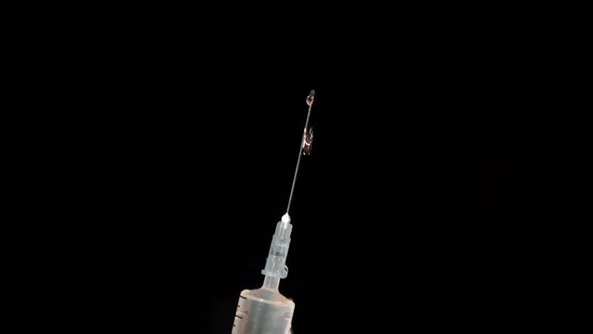 4K Hypodermic Syringe On Black Background. UHD Stock Video Stock