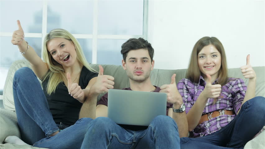 Guy And Two Girls Show Thumbs Top Directly Into The Camera Happy