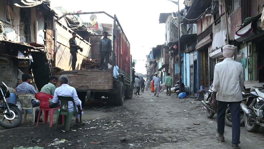 MUMBAI, INDIA - 12 JANUARY 2015: People Passing Through A Dirty Street ...