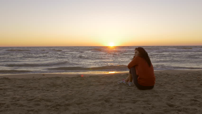 Sad Lonely Woman Standing Alone Against A Beautiful Sunset Stock ...