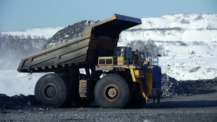 Mine Dump Trucks In Kennecott Copper Mine In Central Utah. Dumping Ore ...