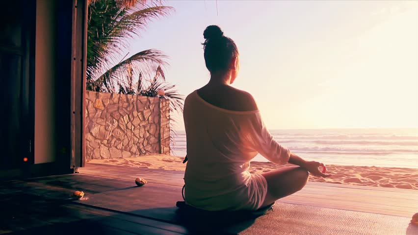 Meditation Near The Sea & Doing Yoga On A Beach At Sunrise Stock ...