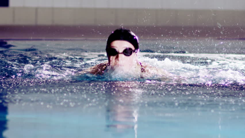 Slow Motion Shot Of A Professional Male Swimmer Jumping Off Swim Start ...