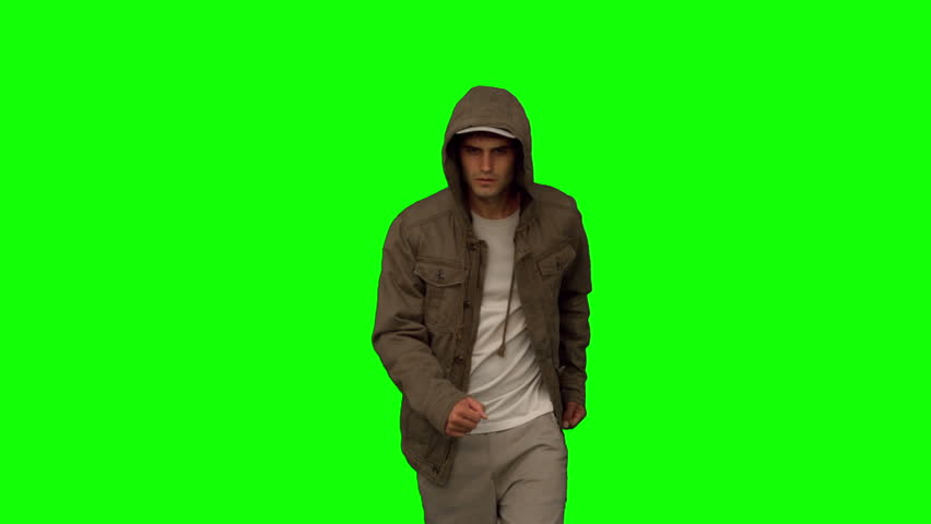 Man With A Coat Walking Toward Camera On Green Screen In Slow Motion ...