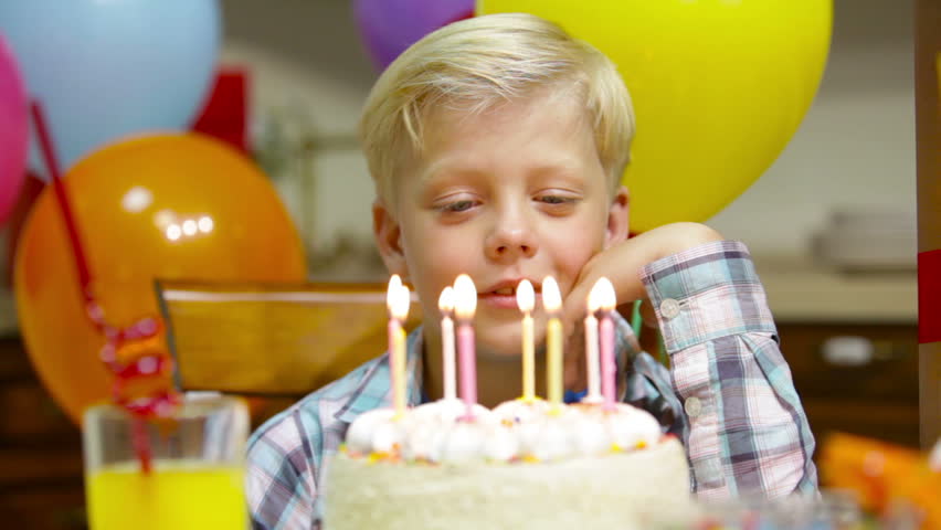 Little Cute Boy Blows Out Candles On Cake And Other Kids Look At He At ...