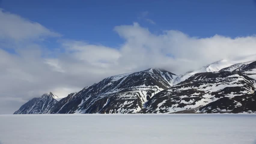 Time Lapse Of Clouds Rolling Over An Arctic Mountain Range And Ice ...