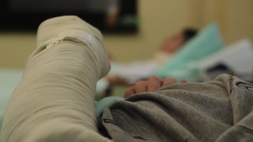 Patient With Broken Arm Lying In Hospital Bed. Plaster In The ...