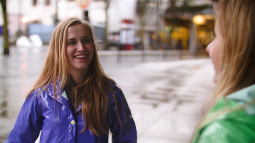 Two Teen Girls Chat And Laugh While They Wait For The Train Stock ...