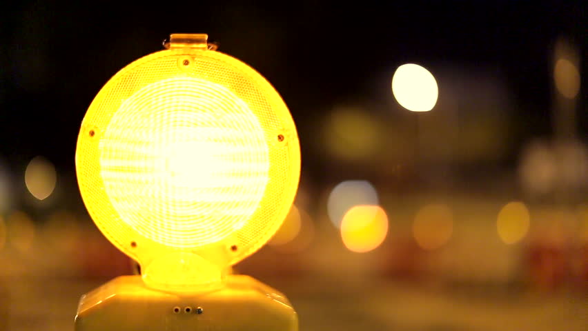 A Caution Sign Is Lit Up By A Blinking Yellow Warning Light Stock ...