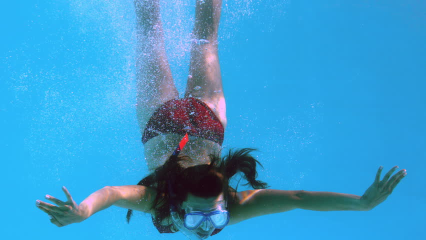 Pretty Brunette Swimming Underwater Into Pool With Snorkel On Her ...