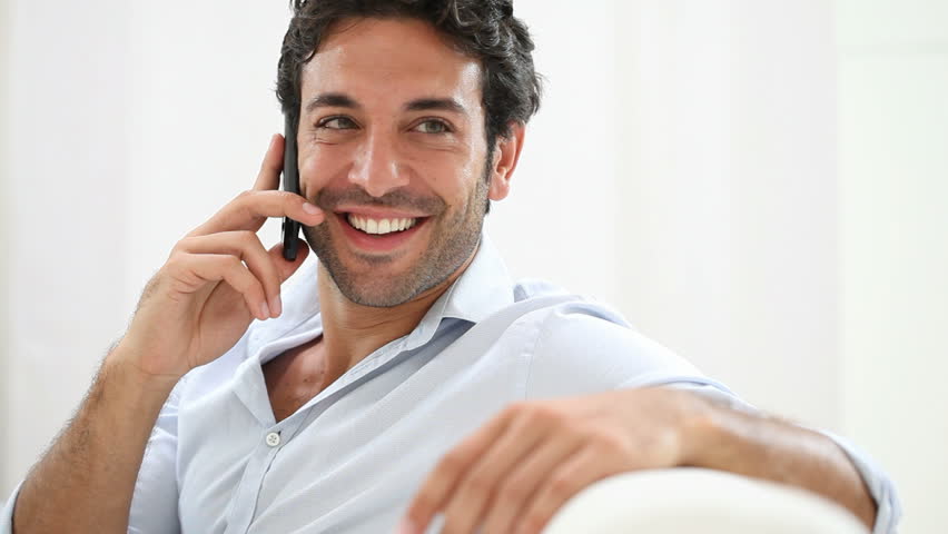 Man Posing While On The Phone Against A White Background Stock Footage ...